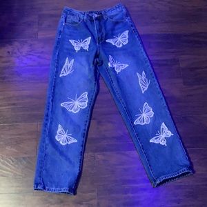 Blue jeans with butterfly print on the front